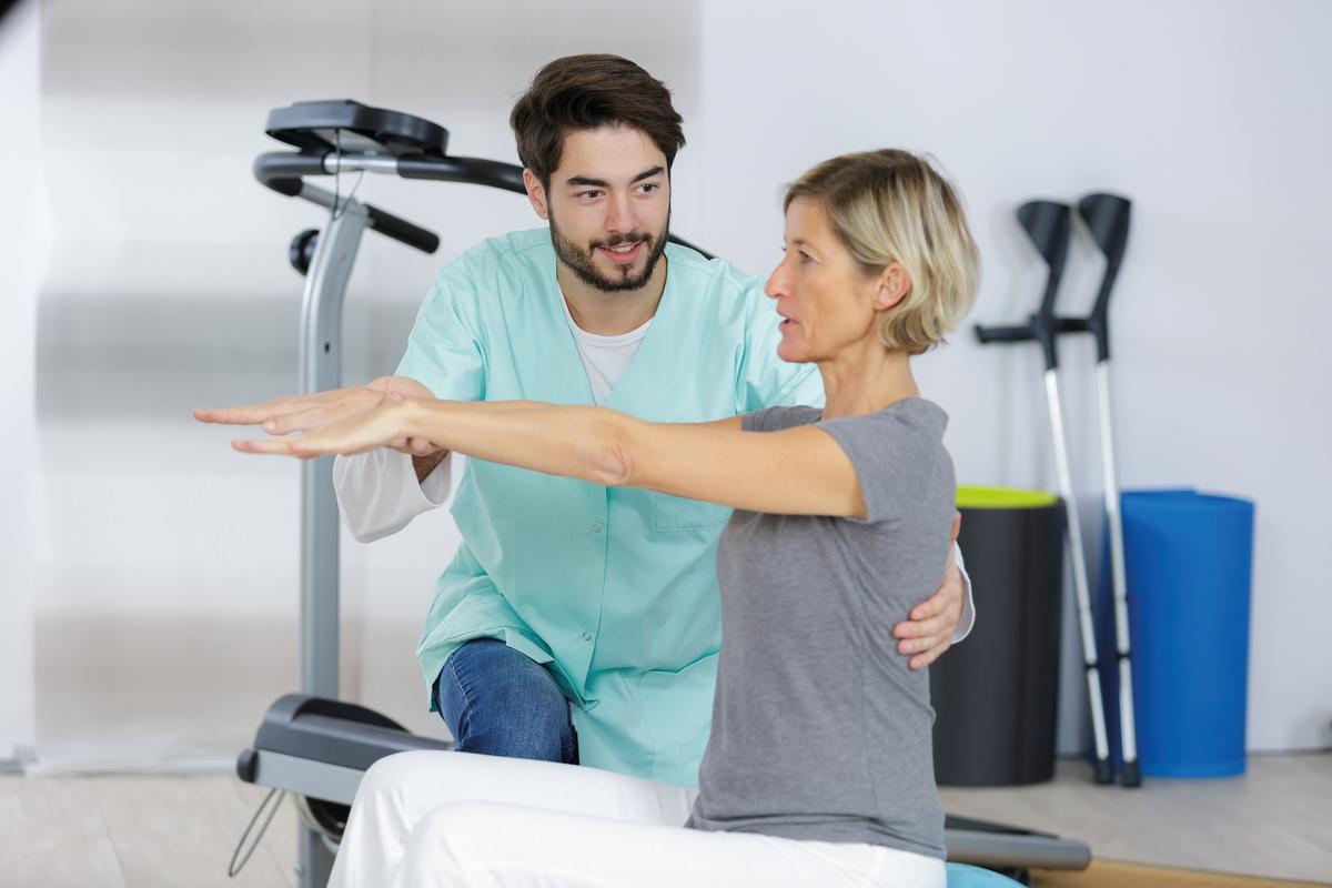 Physiotherapeut macht Übungen mit einer Patientin