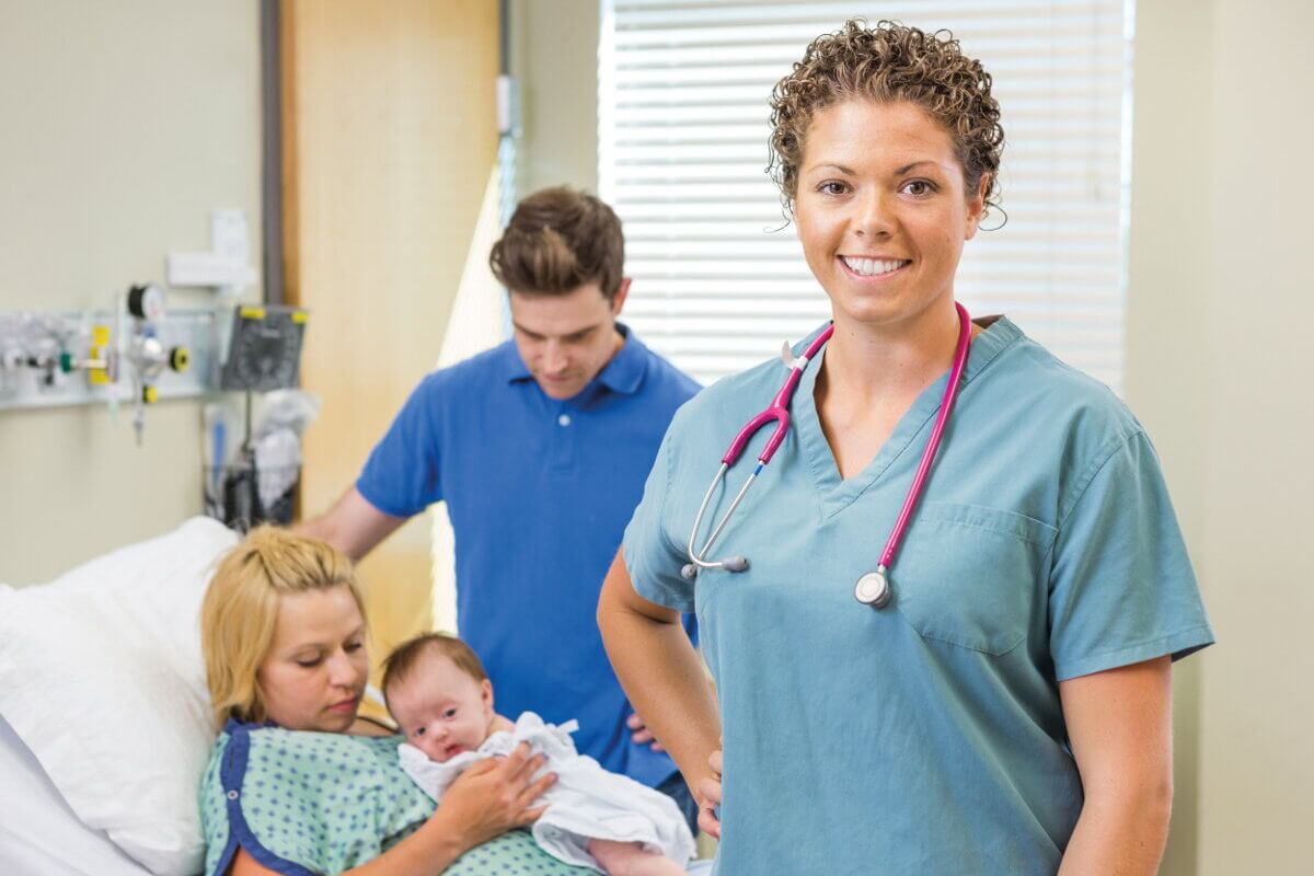 Entbindungspflegerin mit Neugeborenem und Eltern